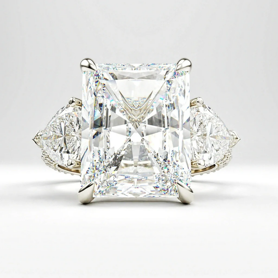 Bespoke three-stone engagement ring with a radiant cut centre diamond and pear cut side stones