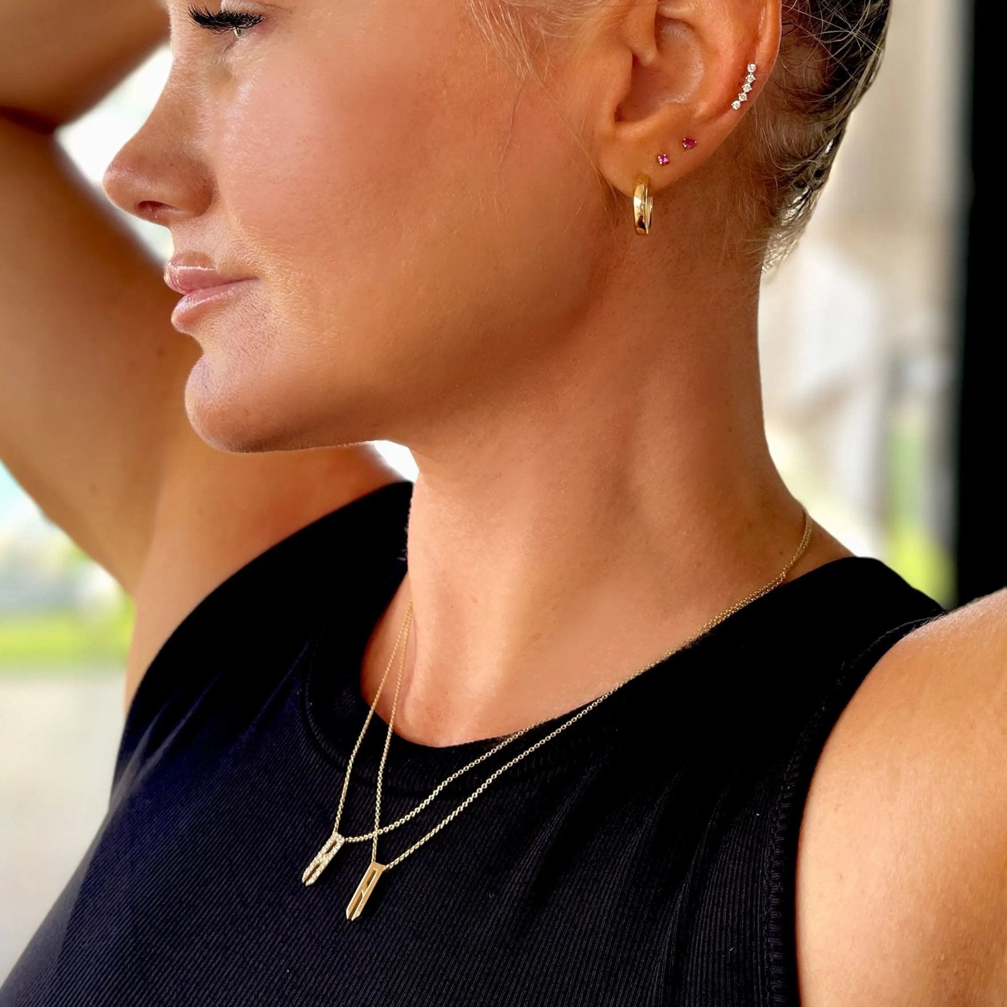 solid gold initial necklace shown with the diamond initial necklace