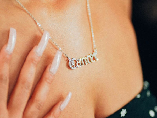 Name Necklace in hand.