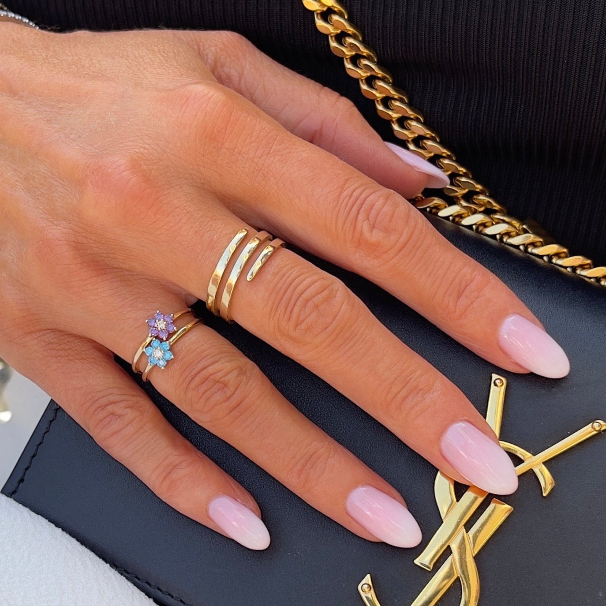 solid gold flower rings in amethyst and blue topaz styled