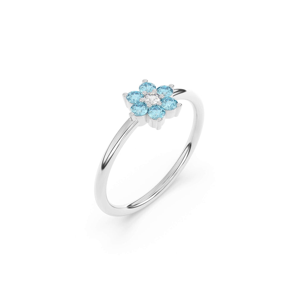 blue topaz flower ring in 14k white gold with a diamond centre stone