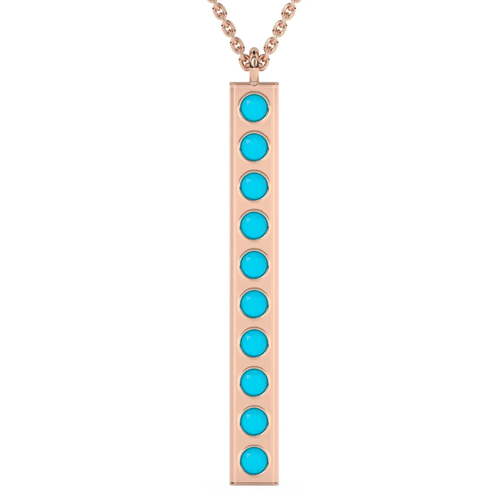 solid gold pendant handmade with turquoise beads bezel set into a 14k solid gold