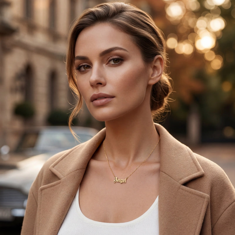 Old English gold name necklace worn with a camel coat