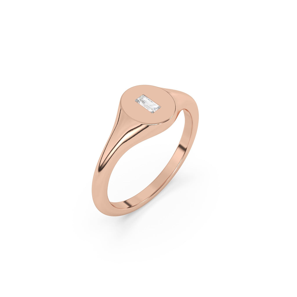 solid gold oval signet ring set with a baguette diamond